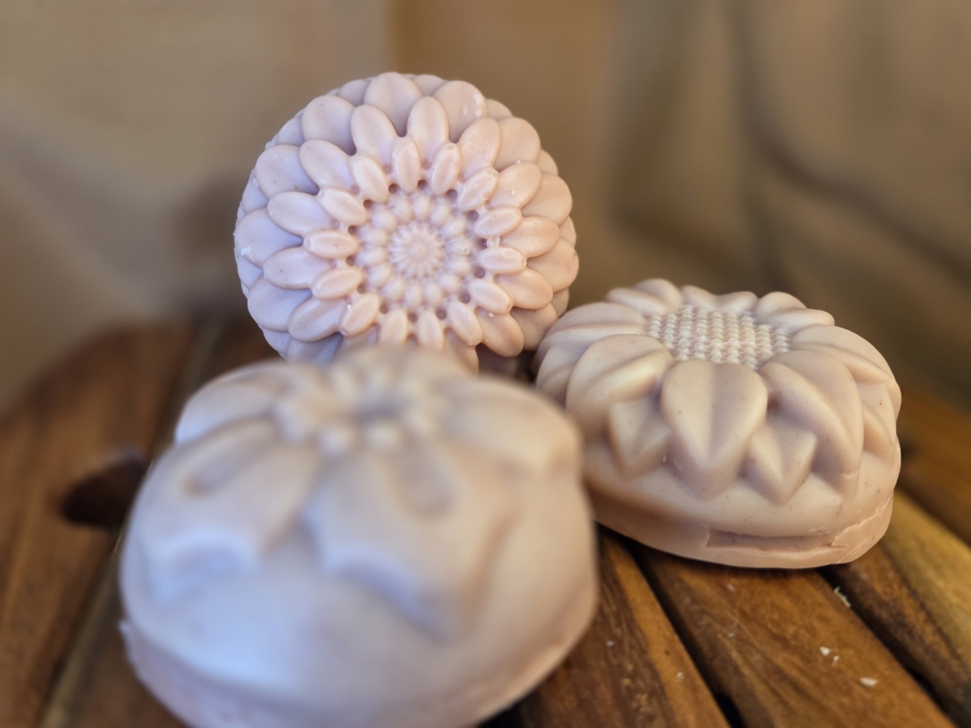 Dusty-rose soaps molded as chrysanthemum, sunflower, and daisy flowers