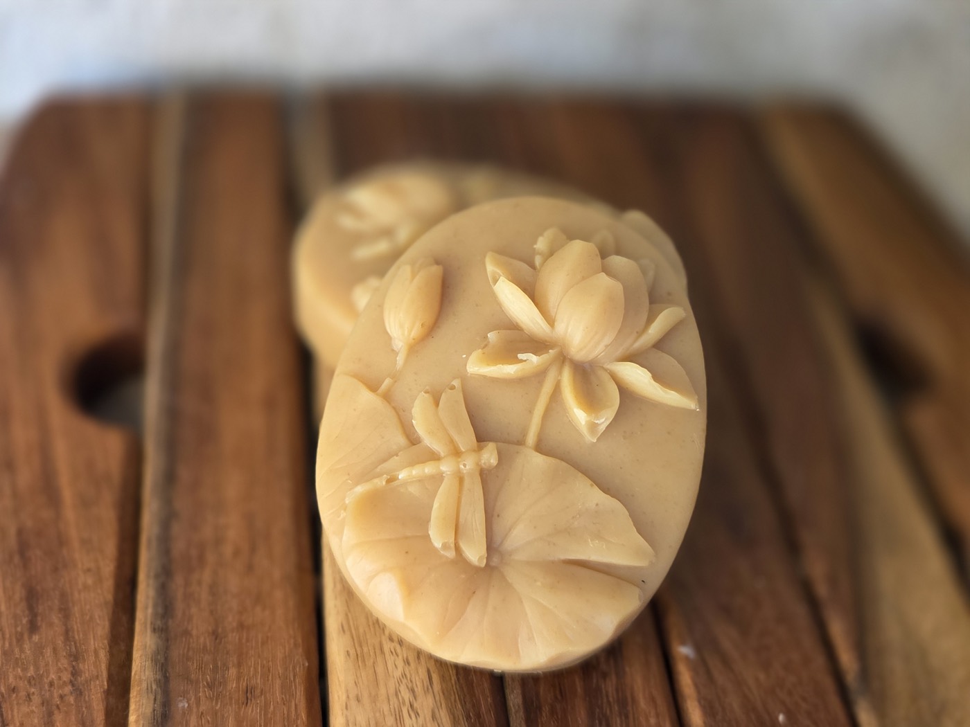 Golden oval soap bars with lotus flower and dragonfly relief