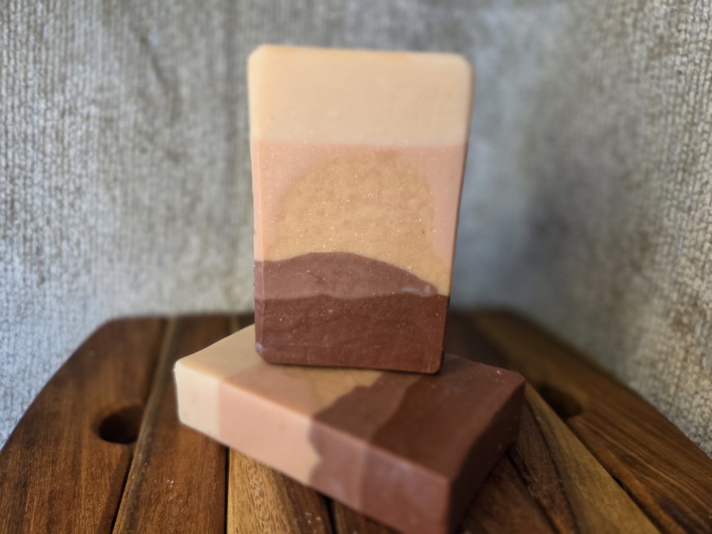 Layered soap bar with a sunset landscape design of cream, pink, and brown